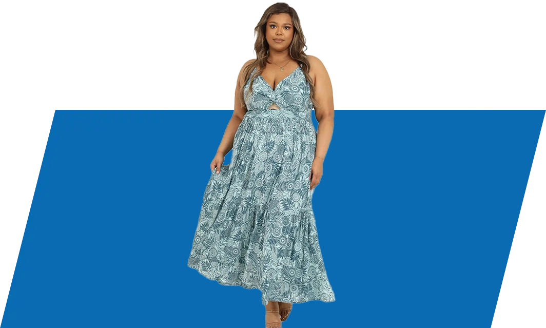 A woman standing in front of a blue background.